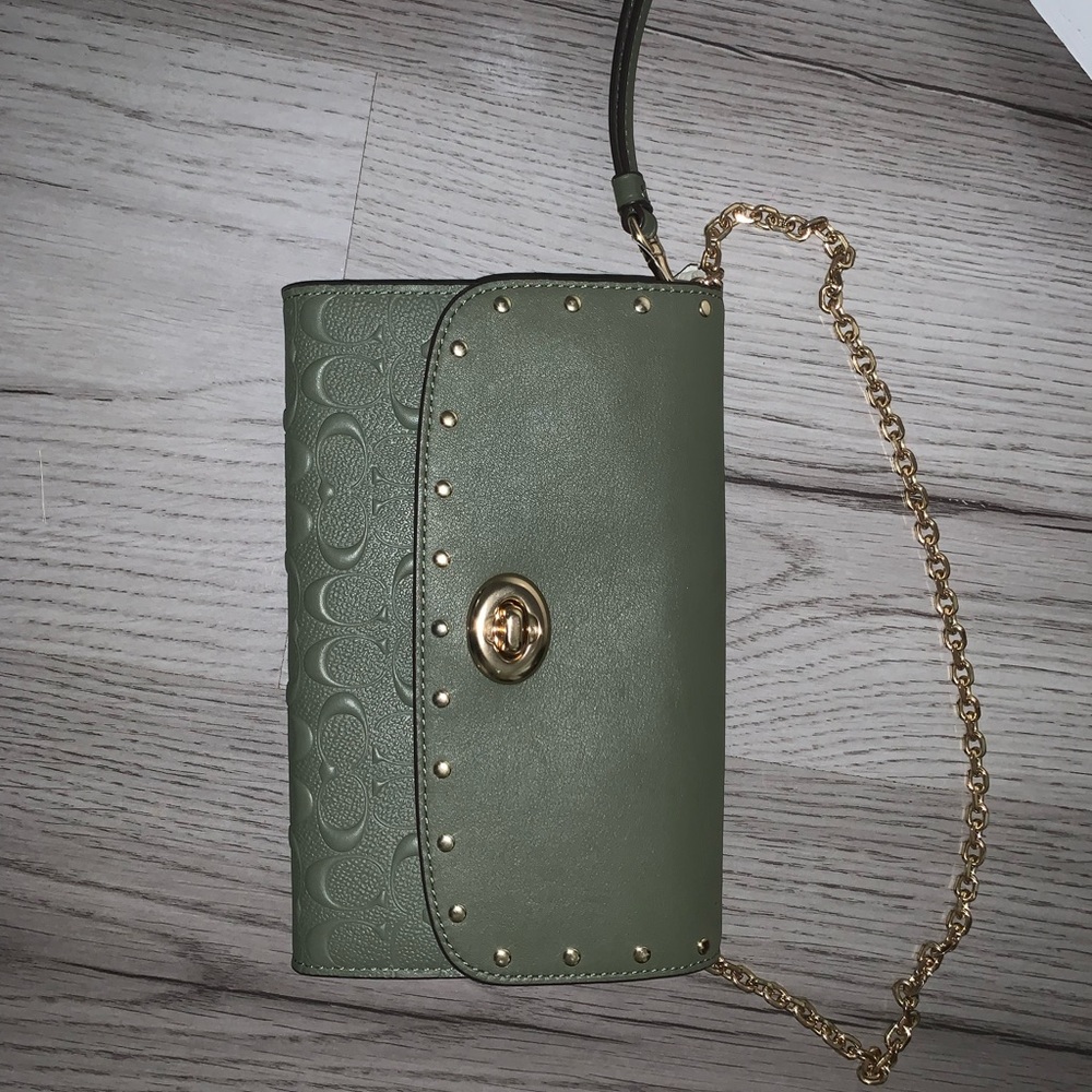 Coach turnlock embossed wristlet with added chain.